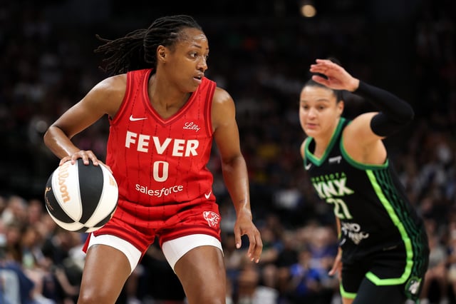 Kelsey Mitchell #0 of the Indiana Fever works around Kayla McBride #21 of the Minnesota Lynx during the first quarter of the championship game of the 2025 Commissioners Cup at Target Center on July 1, 2025 in Minneapolis, Minnesota.