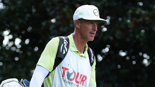 Scottie Scheffler's caddie, Ted Scott, walks the 17th fairway during the final round of the TOUR Championship 2025.