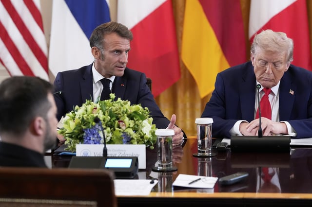 France's President Emmanuel Macron speaks as President Donald Trump, right, listens during a meeting with Ukrainian President Volodymyr Zelenskyy, foreground left, and European leaders in the East Room of the White House, Monday, Aug. 18, 2025, in Washington. (AP Photo/Alex Brandon)