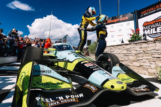 MILWAUKEE - AUGUST 24: Christian Rasmussen, driver of the #21 Ed Carpenter Racing Chevrolet, hugs teammate, Alexander Rossi, in victory lane after winning the NTT IndyCar Series Snap-On Milwaukee Mile 250 at the Milwaukee Mile on Aug. 24, 2025, in Milwaukee. Photo: Joe Skibinski/Penske Entertainment