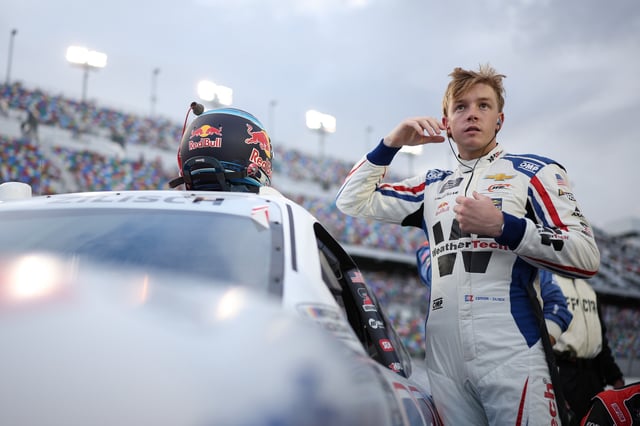 Connor Zilisch, driver of the #88 WeatherTech Chevrolet, prepares to climb into his car prior to the NASCAR Xfinity Series Wawa 250 Powered By Coca-Cola at Daytona International Speedway on August 22, 2025 in Daytona Beach, Florida.