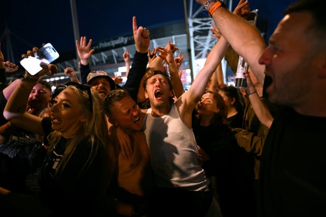 Oasis fans rock out last month during the band's first tour in 16 years in Cardiff, Wales