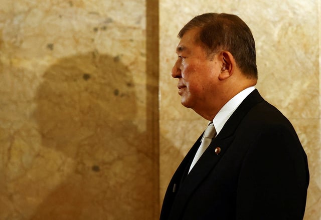 Japan's Prime Minister Shigeru Ishiba, wearing a formal attire, walks toward the upper house hall to attend an opening ceremony of the parliamentary session in Tokyo, Japan August 1, 2025.  REUTERS/Issei Kato/File photo