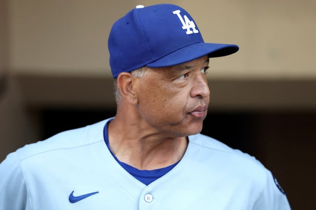 Manager Dave Roberts of the Dodgers looks on from the dugout during a game against the San Diego Padres at Petco Park on August 22, 2025 in San Diego. (Photo by Sean M. Haffey/Getty Images)