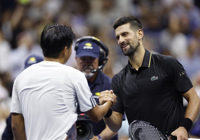 Tennis - U.S. Open - Flushing Meadows, New York, United States - August 24, 2025 Serbia's Novak Djokovic shakes hands with Learner Tien of the U.S. after winning his first round match REUTERS/Eduardo Munoz