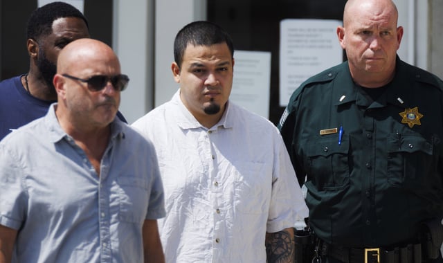 Kilmar Abrego Garcia, center, leaves the Putnam County Jail, Friday, Aug. 22, 2025, in Cookeville, Tenn. (AP Photo/Brett Carlsen)