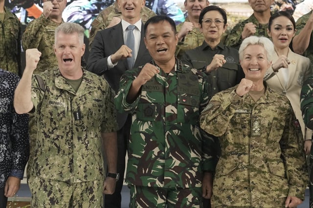 From left, Commander of US Indo-Pacific Command Adm. Samuel Paparo, Deputy Commander of the Indonesian Armed Forces Gen. Tandyo Budi Revita, and Canada's Chief of the Defence Staff Gen. Jennie Carignan, pose for photographers during the opening ceremony of Super Garuda Shield 2025, an Indonesia-US annual large-scale joint military exercise that brings together forces from multiple countries, in Jakarta, Indonesia Monday, Aug. 25, 2025. (AP Photo/Tatan Syuflana)