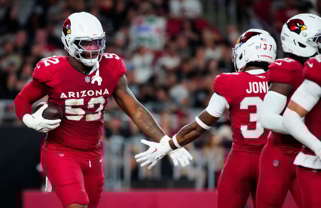 Cardinals edge rusher Jordan Burch (52) celebrates a forced fumble against the Raiders during a preseason game at State Farm Stadium in Glendale on Aug. 23, 2025.