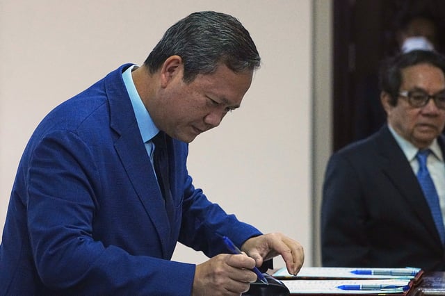 Cambodian Prime Minister Hun Manet registers before entering the session on the draft law on amending the law on nationality in the National Assembly in Phnom Penh Cambodia, Monday, Aug. 25, 2025. (AP Photo/Heng Sinith)