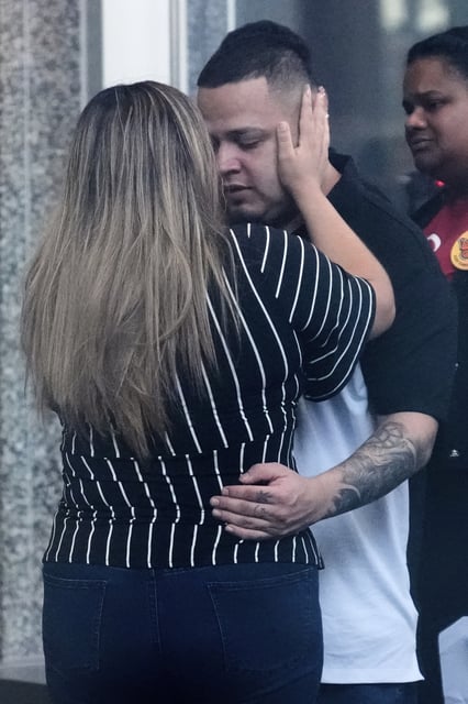 Jennifer Vasquez Sura, left, hugs her husband Kilmar Abrego Garcia at the Immigration and Customs Enforcement field office in Baltimore, Monday, Aug. 25, 2025. (AP Photo/Stephanie Scarbrough)