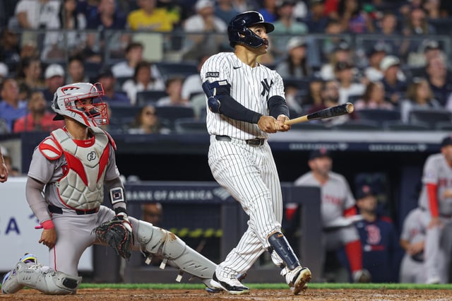NEW YORK, NEW YORK - AUGUST 24: Trent Grisham #12 of the New York Yankees hits a solo home run during the fifth inning against the Boston Red Sox at Yankee Stadium on August 24, 2025 in New York City.