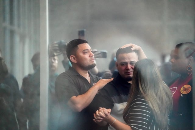 Kilmar Abrego Garcia holds wife Jennifer Vasquez Sura's hand as he appears for a check-in at the ICE Baltimore field office in Maryland on Aug. 25, 2025.