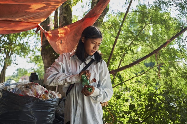 Isela Santiago Morales, who works with her family collecting PET bottles, sorts recyclables at the municipal dump in Axtla de Terrazas, Mexico, Wednesday, Aug. 20, 2025. (AP Photo/Mauricio Palos)