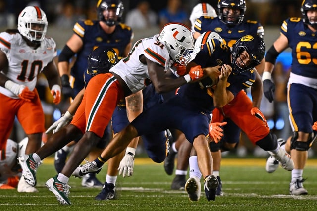 Miami Hurricanes linebacker Wesley Bissainthe (31) tackles  California Golden Bears quarterback Fernando Mendoza (15) while running for yardage during Miami's win Iat Memorial Stadium in Berkeley, Calif., on Oct. 5. Bissainthe's hit helped Miami complete its comeback win against Cal. (Jose Carlos Fajardo/Bay Area News Group)