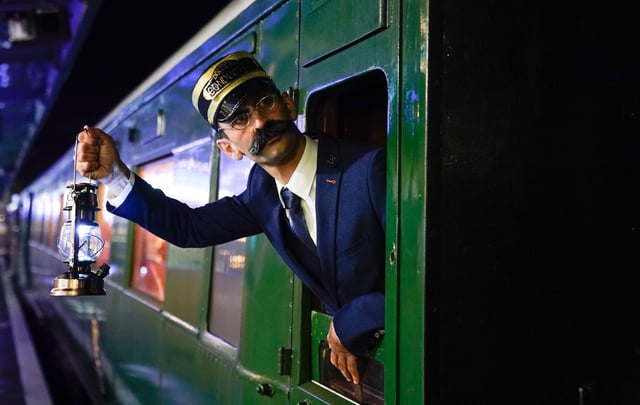 An actor playing the role of the Conductor, poses for a photograph on the Polar Express Train Ride at the Swanage Railway in Dorset, a festive-themed train journey based on the Polar Express book and film, which invites visitors to travel in their pyjamas and dressing gowns as they journey from Swanage to the ‘North Pole’. Picture date: Thursday November 16, 2023. (Photo by Andrew Matthews/PA Images via Getty Images)