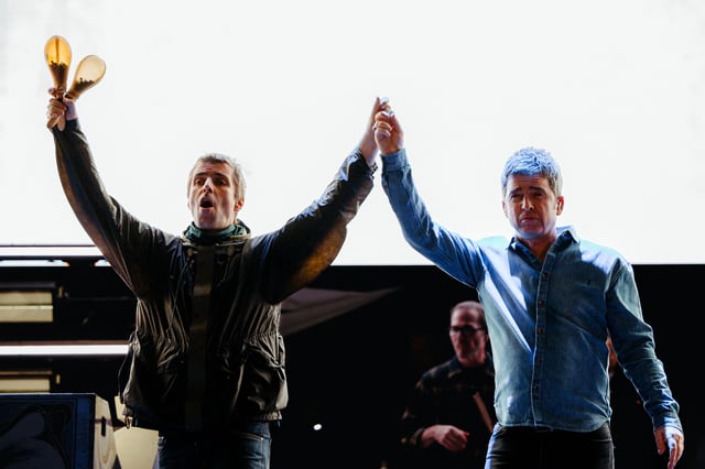 Liam and Noel Gallagher walked onto the Rogers Stadium stage hand in hand for Oasis’ first performance in Toronto on Aug. 24, 2025. 