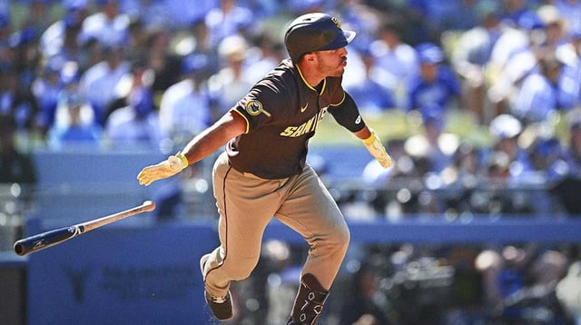 Aug 17, 2025; Los Angeles, California, USA; San Diego Padres outfielder Ramon Laureano (5) doubles against the Los Angeles Dodgers during the eighth inning at Dodger Stadium. Mandatory Credit: Jonathan Hui-Imagn Images