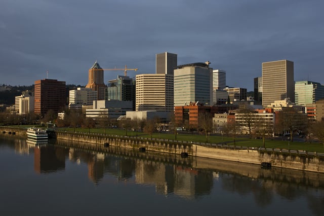 The downtown skyline is reflected in the flowing Willamette River at sunrise on February 11, 2012 in Portland, Oregon.
