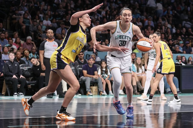 Jul 3, 2025; Brooklyn, New York, USA;  New York Liberty forward Breanna Stewart (30) drives past Los Angeles Sparks forward Dearica Hamby (5) in the third quarter at Barclays Center. Mandatory Credit: Wendell Cruz-Imagn Images/File Photo