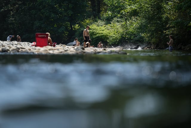 People cool off in Lynn Creek in North Vancouver, B.C., on Thursday, July 6, 2023. THE CANADIAN PRESS/Darryl Dyck
