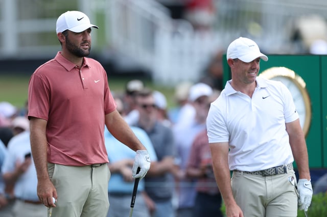 Scottie Scheffler of the United States and Rory McIlroy of Northern Ireland look on from the ninth tee during the first round of the TOUR Championship 2025 at East Lake Golf Club on August 21, 2025 in Atlanta, Georgia.