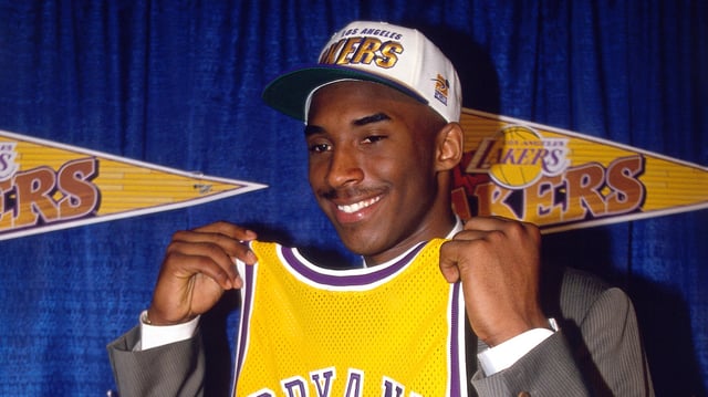 Kobe Bryant holds a Los Angeles Lakers jersey after being the 13th overall pick in the 1996 NBA Draft by the Charlotte Hornets, who then traded his draft rights to the Los Angeles Lakers on July 11, 1996 in Inglewood, California.