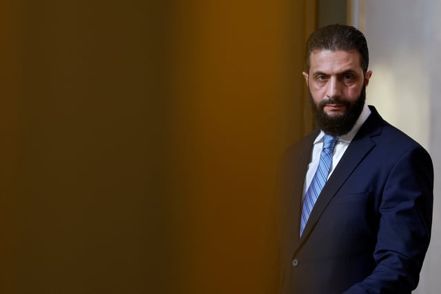 Syrian President Ahmed al-Sharaa listens to the speech of French President Emmanuel Macron (not seen) during a joint press conference after a meeting at the Elysee Palace in Paris, France, May 7, 2025. REUTERS/Stephanie Lecocq/Pool/ File Photo
