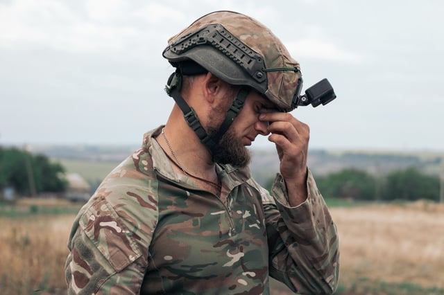 A Ukrainian investigator covers his face while identifying bodies in Donetsk last week. Russia has designs on the region in talks.