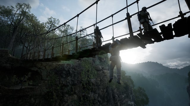 Snake shimmying across a rope bridge while armed guards walk across it in a promotional screenshot for Metal Gear Solid Delta.