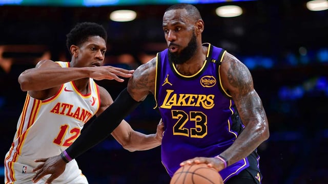 Jan 3, 2025; Los Angeles, California, USA; Los Angeles Lakers forward LeBron James (23) moves the ball against Atlanta Hawks forward De'Andre Hunter (12) during the second half at Crypto.com Arena. Mandatory Credit: Gary A. Vasquez-Imagn Images