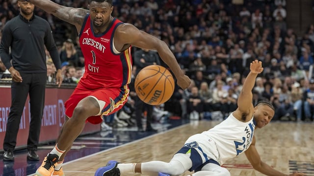 Mar 19, 2025; Minneapolis, Minnesota, USA; New Orleans Pelicans forward Zion Williamson (1) and Minnesota Timberwolves guard Jaylen Clark (22) attempt to go after a loose ball in the second half at Target Center. Mandatory Credit: Jesse Johnson-Imagn Images