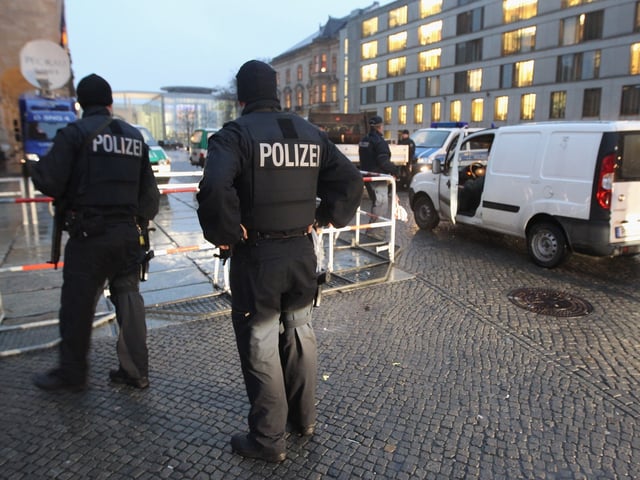 BERLIN - NOVEMBER 22: German police armed with submachine guns check vehicles arriving at the eastern entrance of the Reichstag, seat of the Bundestag, or German parliament, on November 22, 2010 in Berlin, Germany. Heavily-armed police patrolled around the Reichstag and the glass cupola was closed to visitors until further notice today in the wake of rising anti-terrorism precautions in Germany. German Interior Minister Thomas de Maiziere recently announced that Islamic terrorists are planning attacks on German territory to take place towards the end of November and the entire country is on high alert. (Photo by Sean Gallup/Getty Images)