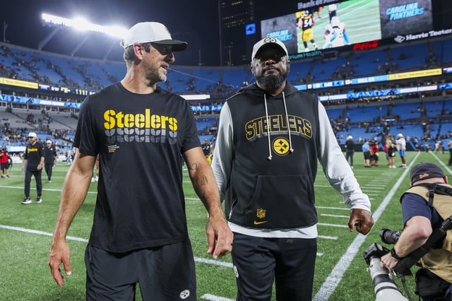 CHARLOTTE, NORTH CAROLINA - AUGUST 21: Aaron Rodgers #8 of the Pittsburgh Steelers and head coach Mike Tomlin walk off the field after a NFL Preseason 2025 game against the Carolina Panthers at Bank of America Stadium on August 21, 2025 in Charlotte, North Carolina.