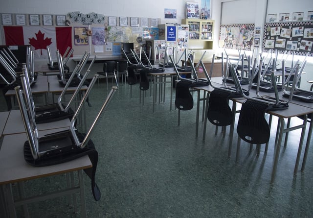 An empty classroom is pictured at Eric Hamber Secondary school in Vancouver, B.C., on Monday, March 23, 2020. THE CANADIAN PRESS/Jonathan Hayward