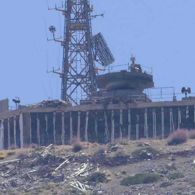 FILE - A damaged Israeli military position targeted by Hezbollah fighters is seen on the top of Mount Hermon in the Israeli-controlled Golan Heights, where the borders between Israel, Syria and Lebanon meet, is seen from Chebaa, a Lebanese town near the border with Israel, south Lebanon, June 26, 2024. U.S., European and Arab mediators are pressing to keep stepped-up cross-border attacks between Israel and Lebanon’s Hezbollah militants from spiraling into a nightmare Middle East-wide war that the world has feared for months. (AP Photo/Hussein Malla, File)