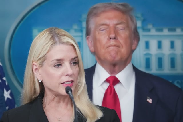 Attorney General Pam Bondi delivers remarks as U.S. President Donald Trump looks on earlier this month.