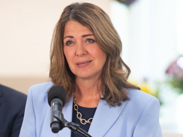  Alberta Premier Danielle Smith is seen at a news conference in Calgary on Aug. 21, 2025. Smith says a fee for COVID-19 vaccinations is necessary due to wastage last season and the absence of federal subsidies this year.
