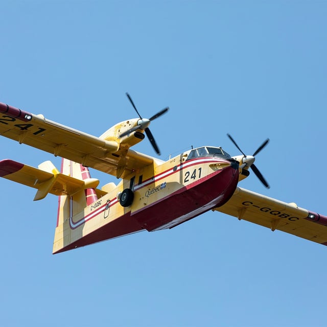 A Quebec Water Bomber helps fight a forest fire in the Irishtown, N.B. area on Monday Aug. 11, 2025. THE CANADIAN PRESS/Ron Ward