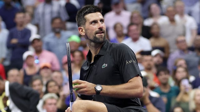 NEW YORK, NEW YORK - AUGUST 24: Novak Djokovic of Serbia hits balls into the crowd after defeating Learner Tien of the United States during their Men's Singles First Round match on Day One of the 2025 US Open at USTA Billie Jean King National Tennis Center on August 24, 2025 in the Flushing neighborhood of the Queens borough of New York City. 