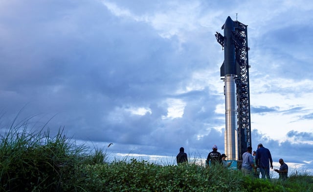 Spectators watch from the dunes as preparations to launch a SpaceX Starship spacecraft continue, at the company's complex in Starbase, Texas, U.S., August 25, 2025. REUTERS/Steve Nesius