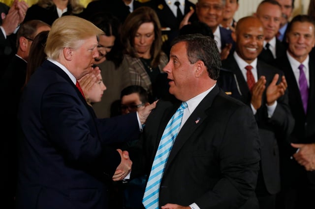 President Donald Trump greets New Jersey Governor Chris Christie after speaking about administration plans to combat the nation's opioid crisis in the East Room of the White House in Washington, on Oct. 26, 2017.