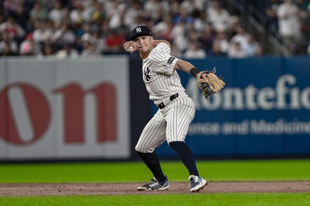 Aug 24, 2025; Bronx, New York, USA; New York Yankees shortstop Anthony Volpe (11) fields a ground ball hit by third baseman Alex Bregman (2) and throws to first for an out during the eighth inning at Yankee Stadium. Mandatory Credit: John Jones-Imagn Images