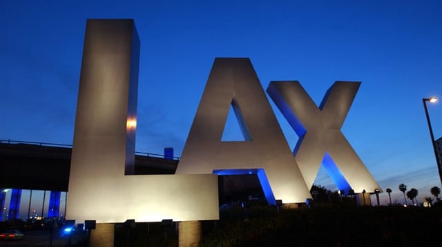 401556 02: Darkness settles around the large LAX letters that welcome travelers to Los Angeles International Airport February 25, 2002, in Los Angeles, CA. Terror threats and suspicious packages at LAX have kept officals busy. A bomb squad investigated a tin of cookies left unattended tonight. (Photo by David McNew/Getty Images)