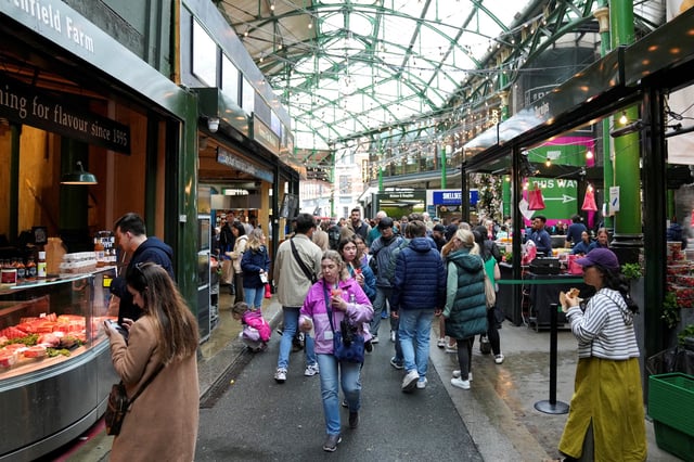 People walk past food stands and market stalls in a Borough Market in London, Britain May 22, 2024. REUTERS/Maja Smiejkowska/File Photo