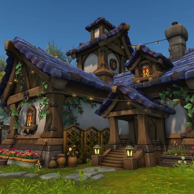 An in-development screenshot of World of Warcraft's player housing, which is coming in the Midnight expansion. A blue-roofed cottage covered in vines and lights sits in a valley.
