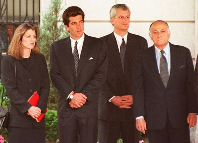 Caroline Kennedy Schlossberg, John F. Kennedy Jr., Edwin Schlossberg and Maurice Tempelsman (L-R) watched together as the casket containing  the body of Jacqueline Kennedy Onassis was placed in a hearse in 1994
