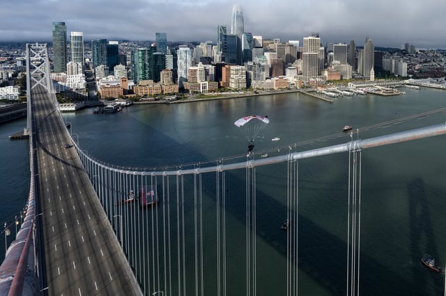 Sean MacCormac skysurfs into a grind on the Bay Bridge in San Francisco on Aug. 23, 2025.