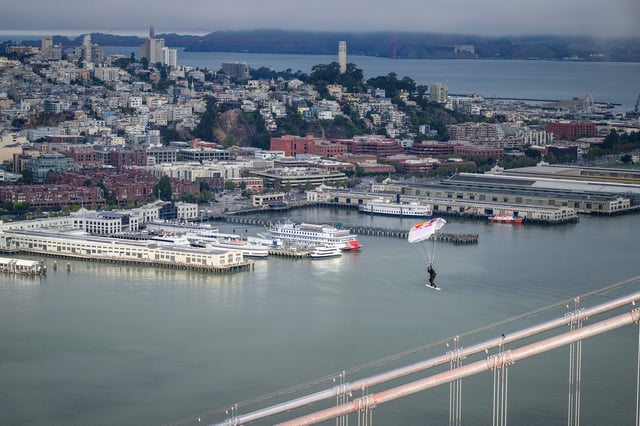 Sean MacCormac skysurfs into a grind on the Bay Bridge in San Francisco on Aug. 23, 2025.
