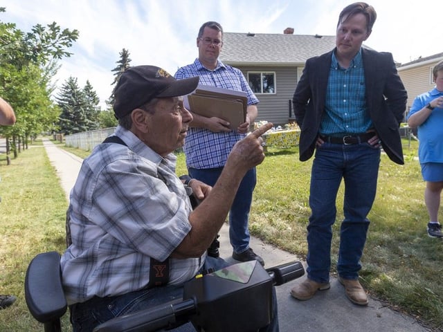 Transportation Minister Devin Dreeshen listens to Tom Ogonoski  speak as he meets with members of Edmonton's Delton and Alberta Avenue community to talk about bike lane projects in their neighbourhoods on Monday, Aug. 25, 2025, in Edmonton.  Greg Southam-Postmedia