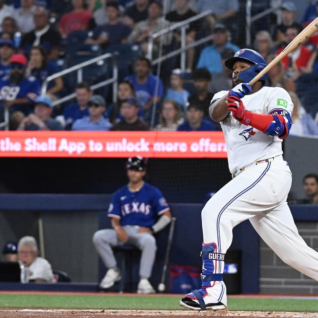 Toronto Blue Jays first baseman Vladimir Guerrero Jr. (27) hits a single against the Texas Rangers in first inning MLB baseball action in Toronto on Sunday, Aug. 17, 2025. THE CANADIAN PRESS/Jon Blacker